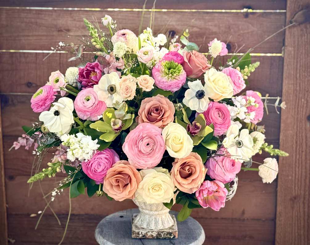 A lovely display of seasonal pink, white and green flowers named after