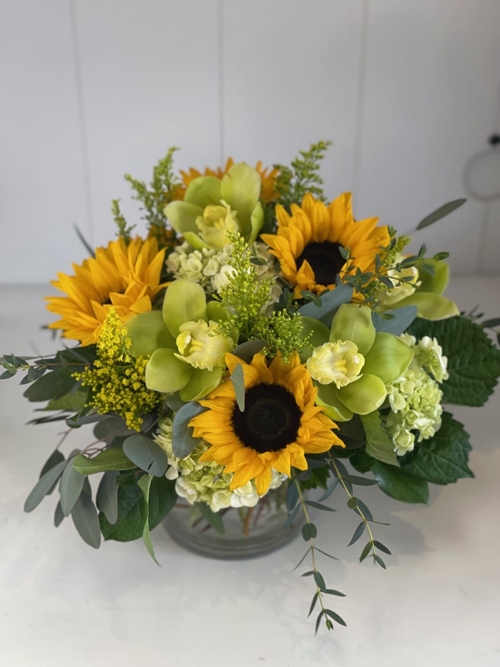 Beautiful golden sunflowers, mini green hydrangeas and cymbidium orchids with a touch