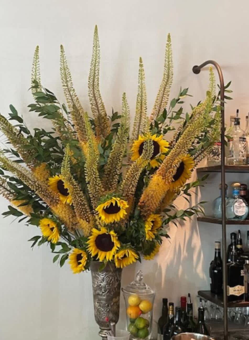 A very tall, grande arrangement of happy Sunflowers, robust Eremurus and soft