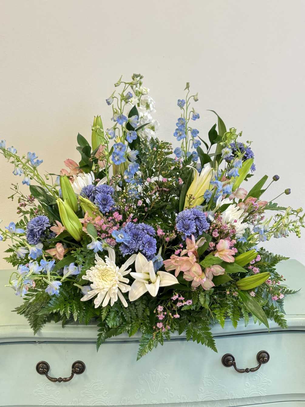 Hints of blue, white and pink colors elegantly adorn the cremation urn.