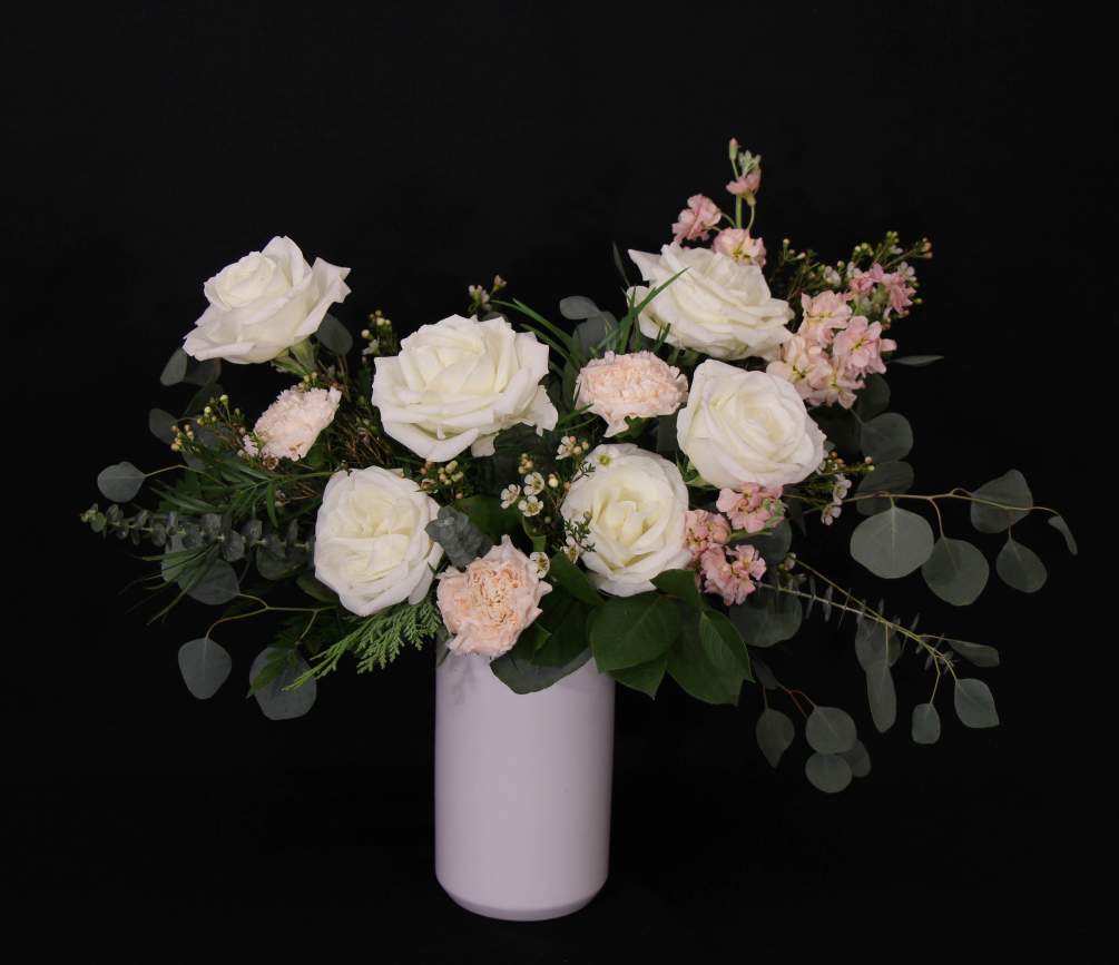 Keep it simple with this beauty. White roses, peach stock, peach carnations