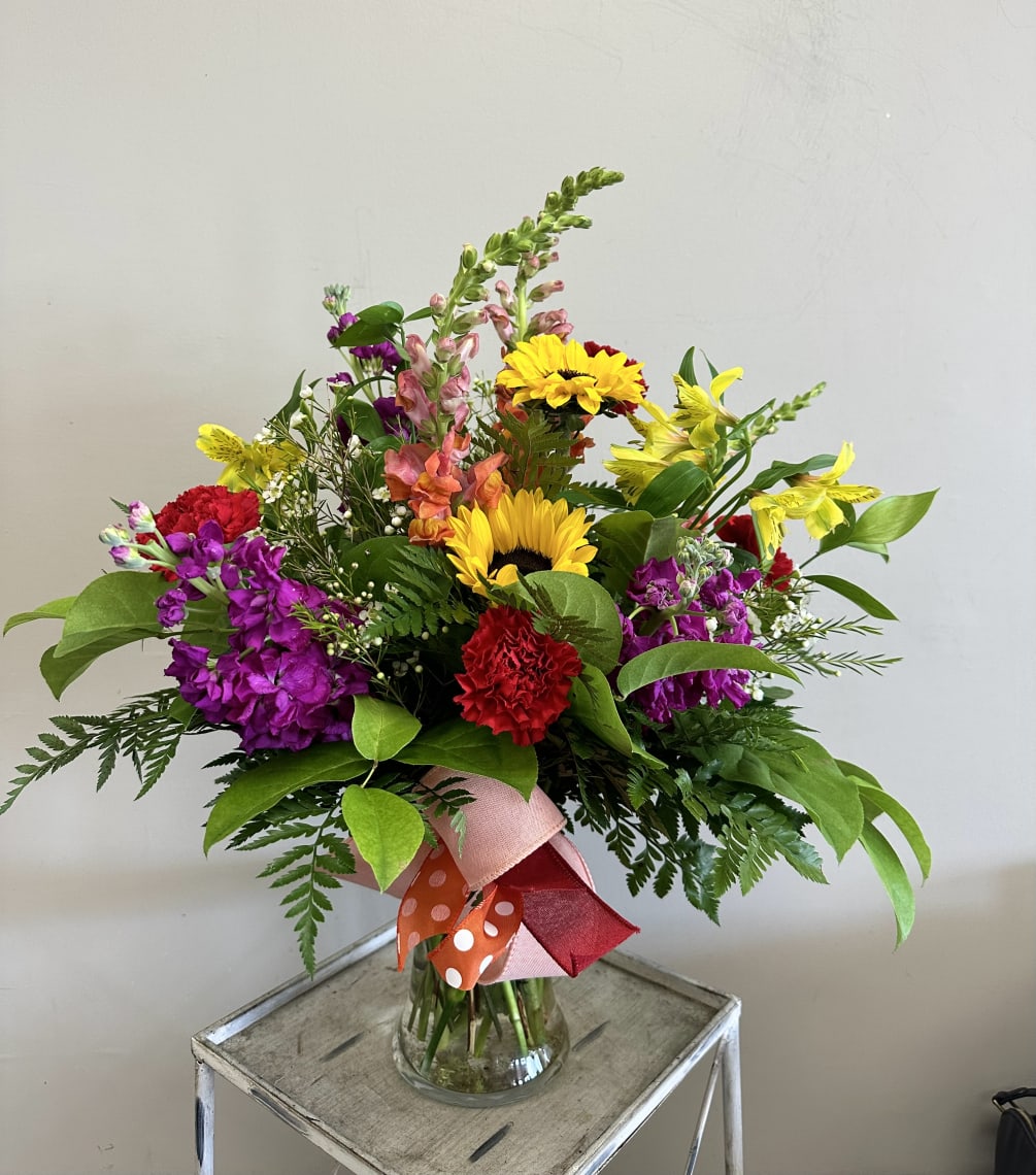 A bright and cheerful mix of snapdragons, sunflowers, stock, alstroemeria and carnations!