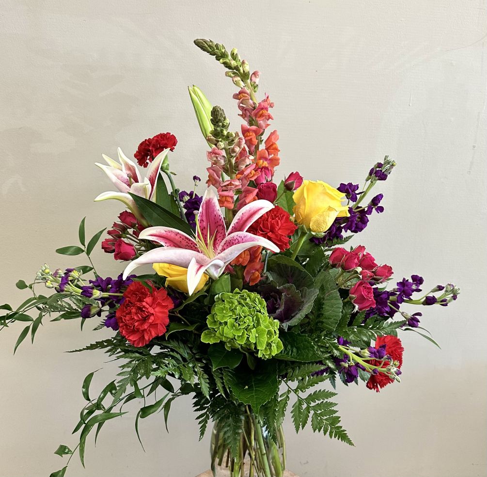 A gorgeous and bright mix of flowers that include stargazer lilies, mini