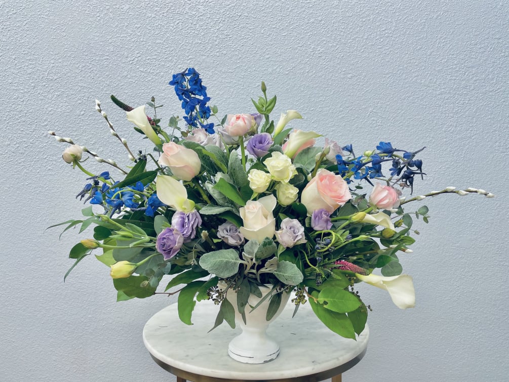 Soft spring hues of cream, blush, blue and white tucked into botanical