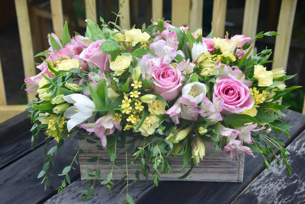 A lush mix of alstroemerias, tulips, and roses with green fillers in