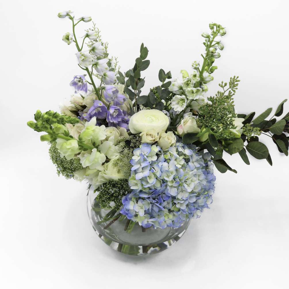 This pale-blue-toned arrangement will add a note of elegance and delicacy to