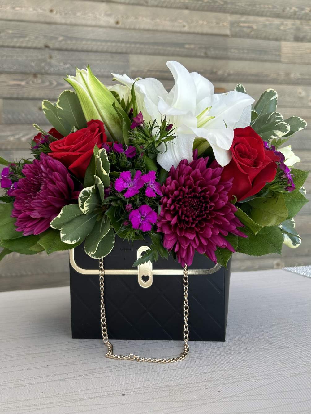 Imagine a floral arrangement inside a small gift purse with a variety