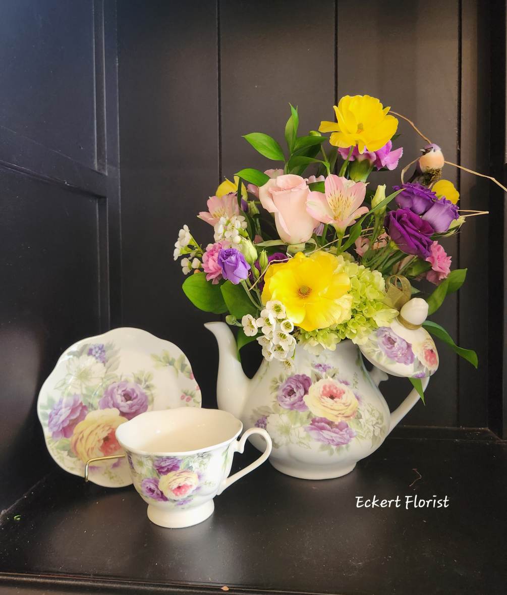 This keepsake porcelain teapot is filled with fresh cut spring colored flowers