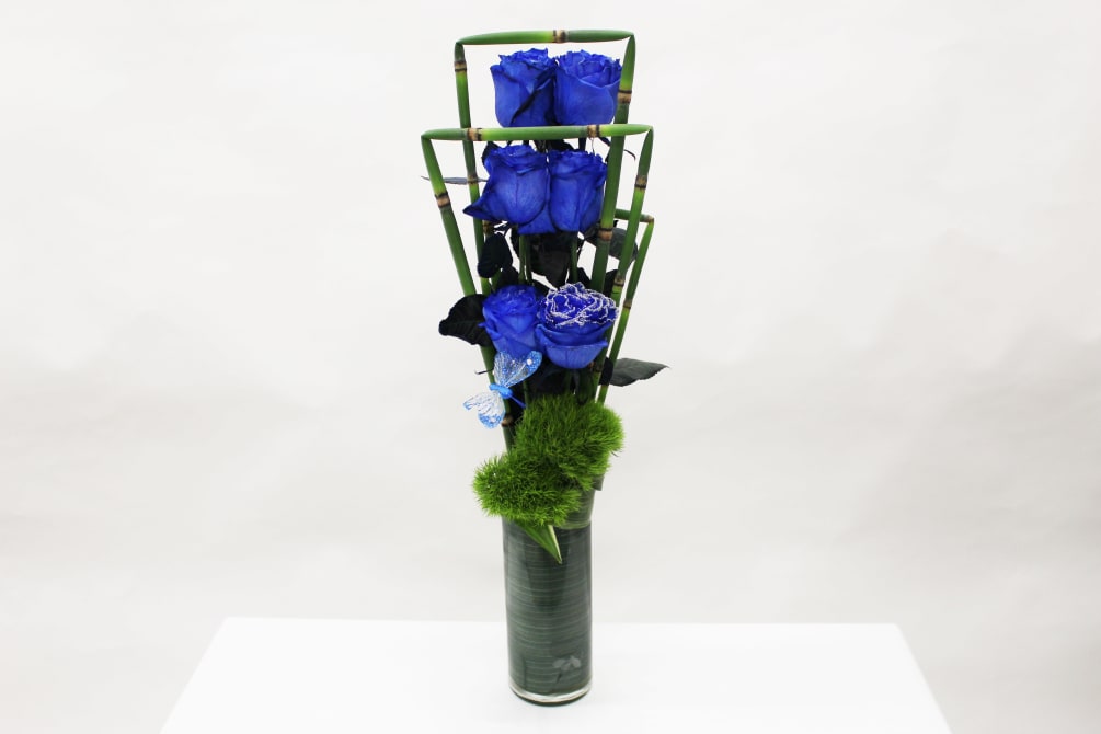 This contemporary design features 6 of our very popular tinted blue roses!!