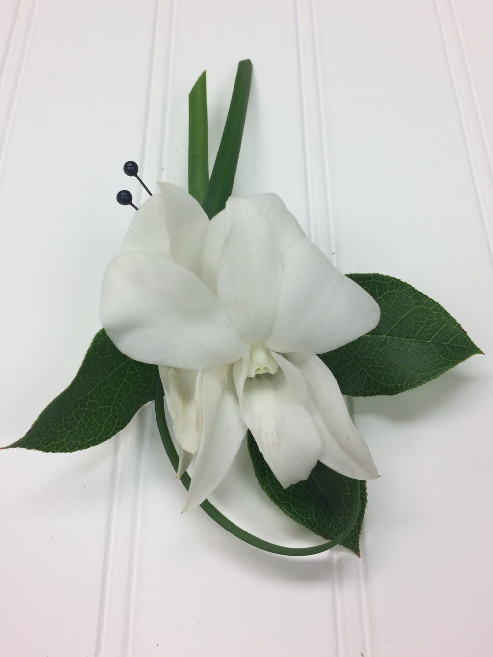 White Dendrobium Orchid accented with lily grass loop and Israli Ruscus
