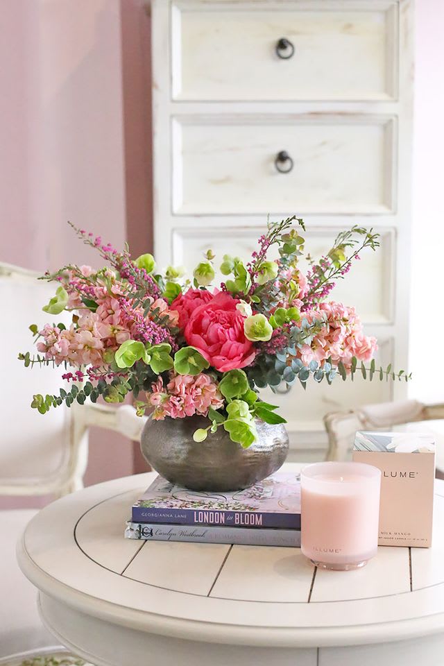 This lovely floral arrangement bursts with vibrant hues and captivating textures. The