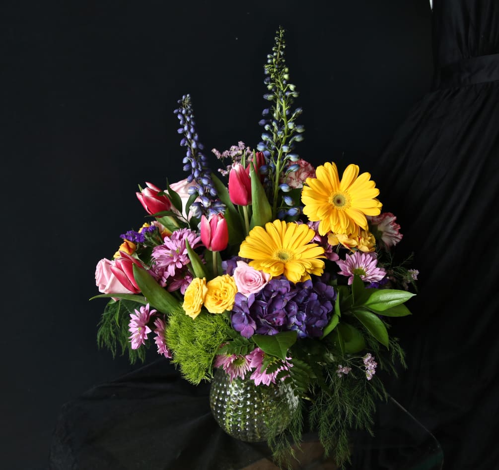 Tulips, gerberas, roses, carnations, and more abound in this colorful and vibrant