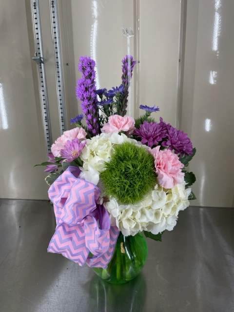 Mixed cut with white hydrangea, pink carnations, purple liatris, and purple daisies