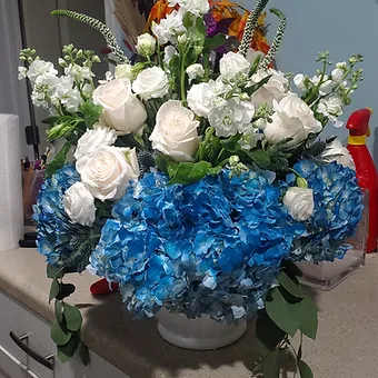 Premium Blue Hydrangea, white roses, veronica, stock, and a mix of premium