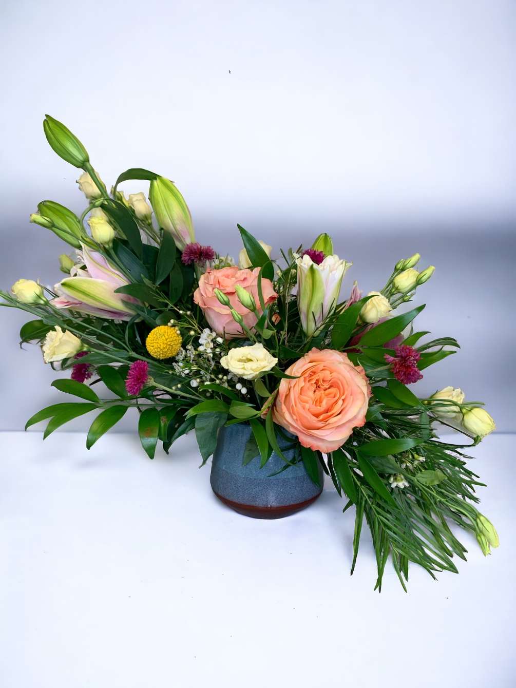 This exquisite flow of elegant flowers in a beautiful ceramic vase is