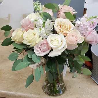 Delicate blend of premium roses, stock and eucaluptus in a gathering vase.