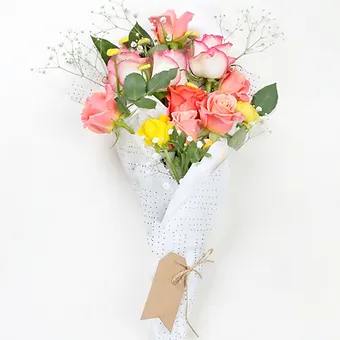 8-10 Beautiful Coral roses and hints of yellow flowers and babysbreath.