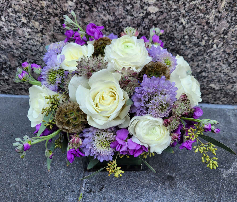 Introducing our Lavender Mist Floral Arrangement, where the timeless beauty of white