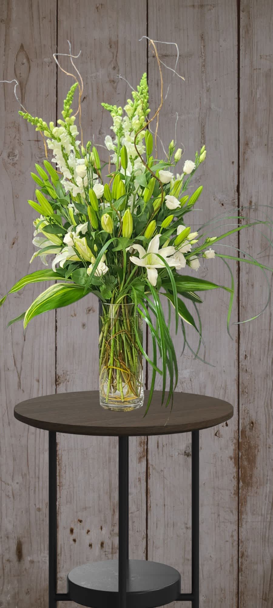 Stunning and Classic. This all white floral arrangement is luxurious and elegant.