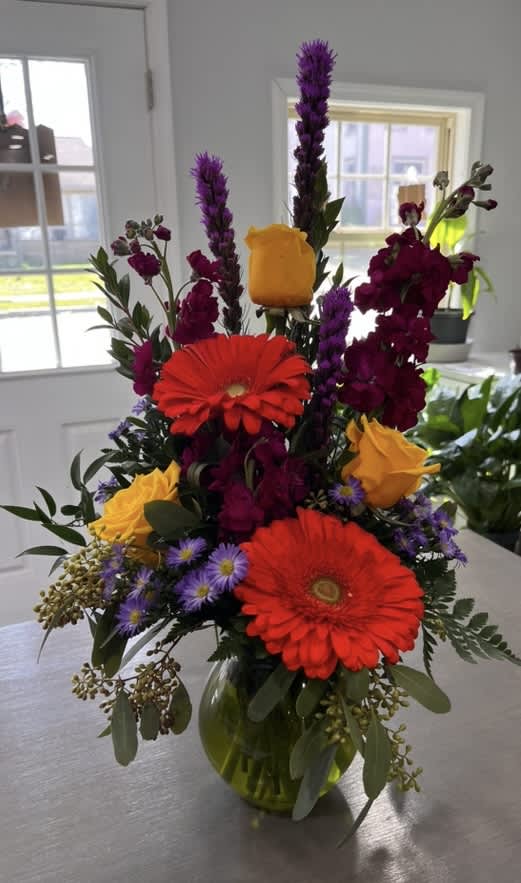 A large beautiful arrangement full of Gerbera Daisies, Iris, Campanulas and 