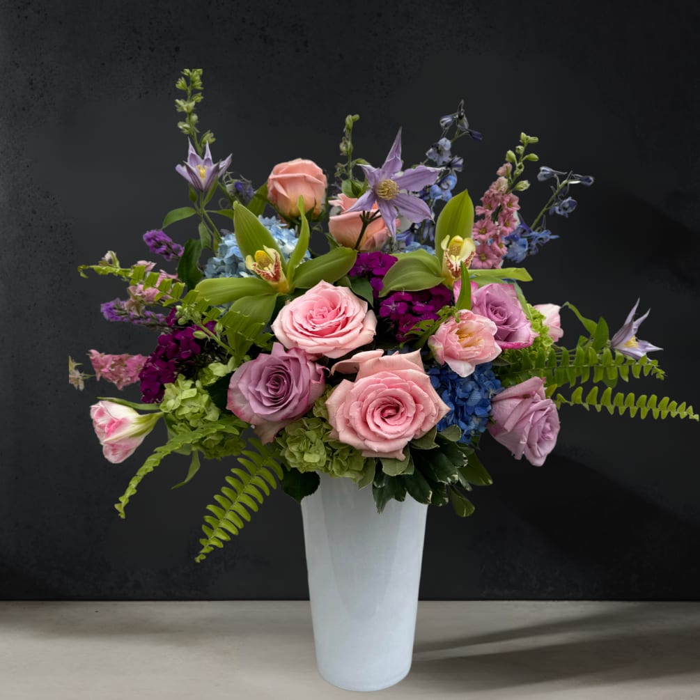 A tall all-around arrangement featuring a mixture of beautiful blooms in various