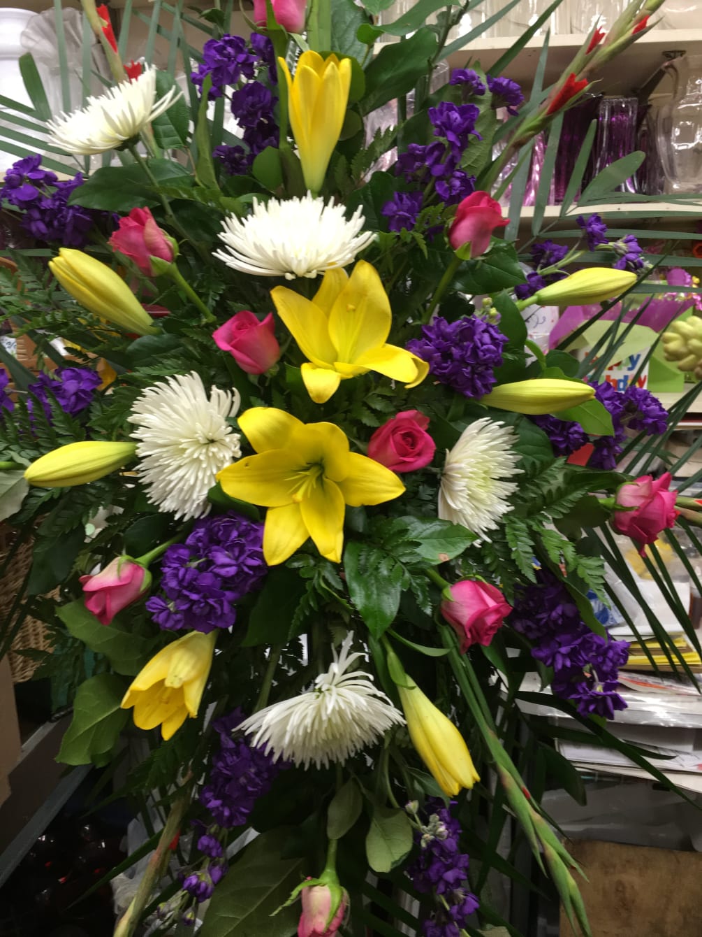 Standing spray colorful with Lilies, Roses, Gladiolas, Stock and spider mums 