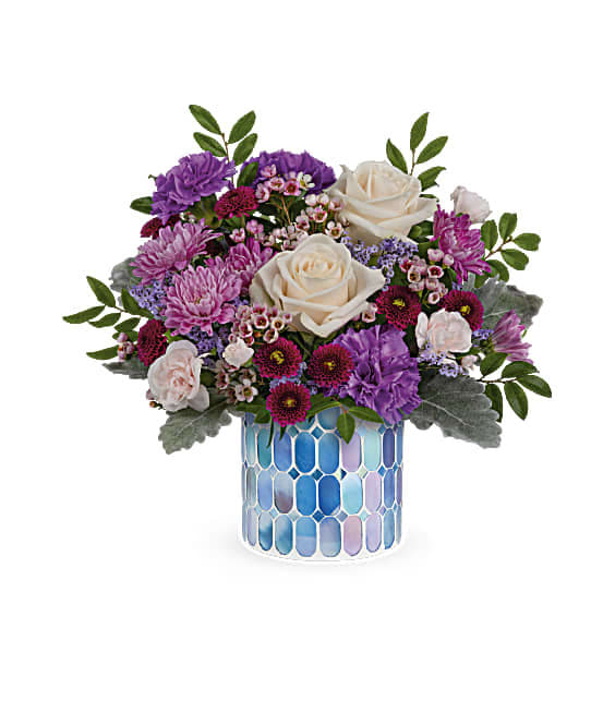 Springtime beauty at its best! Creamy roses and deep purple blooms are