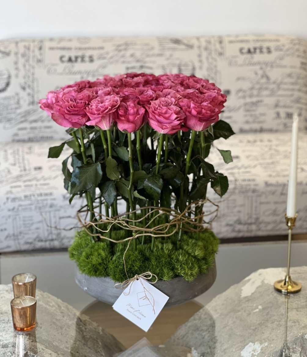 Unique design of roses in a concrete vase. 
The difference between Standard