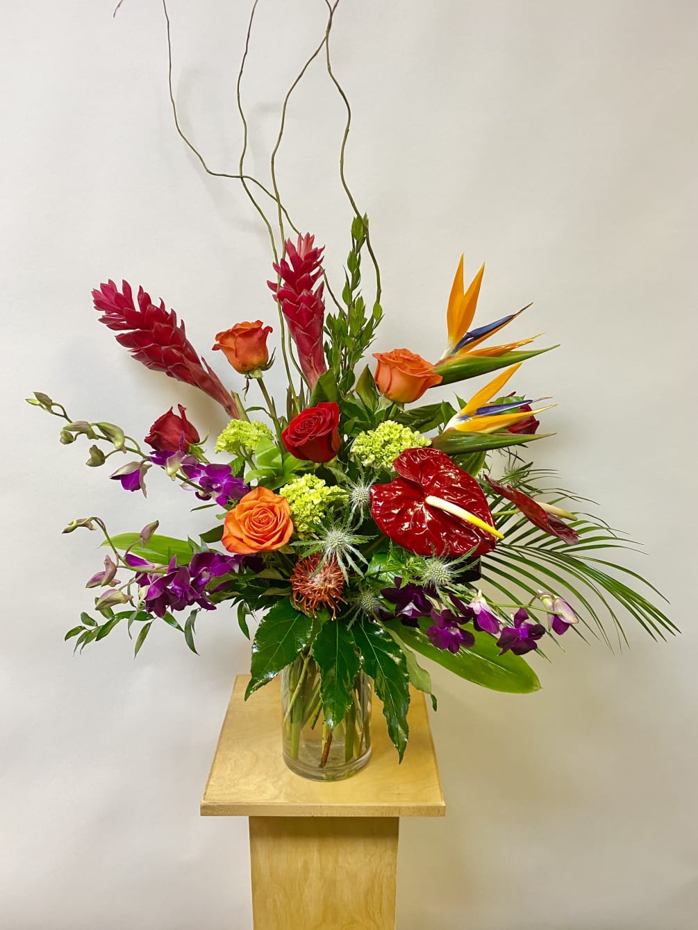 This Tall Tropical Arrangement includes Birds of Paradise, Red Ginger, Red Anthurium