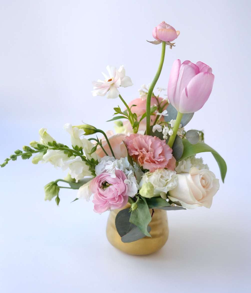 A small and elegant vase arrangement that exudes understated charm. It features