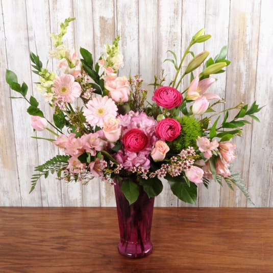 Shades of pink spring flowers in a pink vase designed with modern