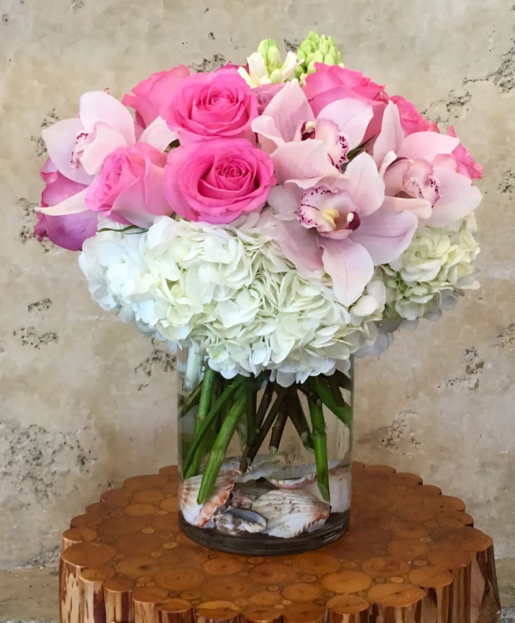 Pink Roses, Hydrangea, Cymbidium Orchid with Sea Shell in glass vase.