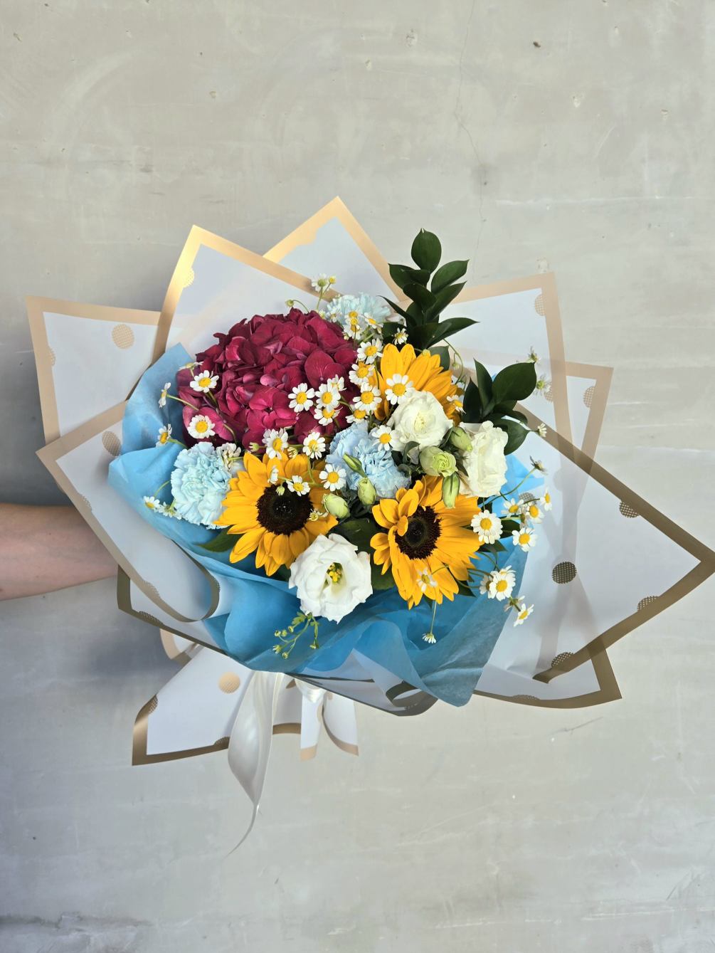 Beautiful bright bouquet with sunflowers,  hydrangea, carnations, lisianthus and daisies