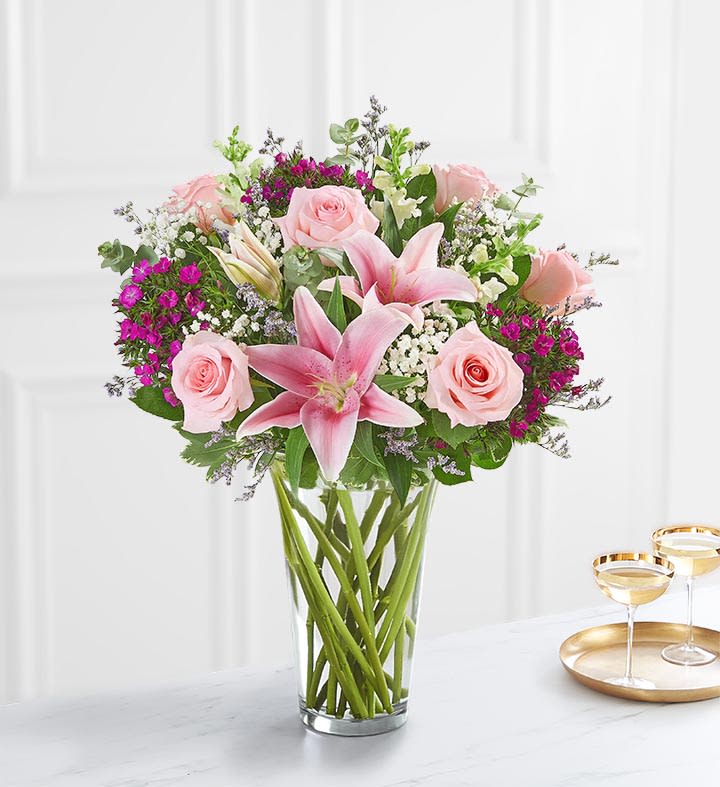 Pink roses, pink lilies, purple dianthus, white snap dragons, baby&#039;s breath, and
