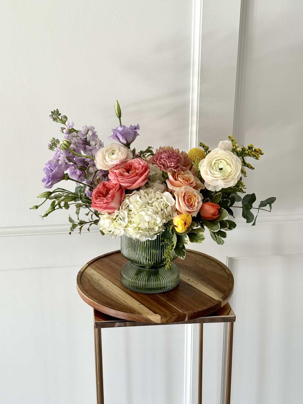 A bright and colorful blend of garden roses, tulips, hydrangea and ranunculus
