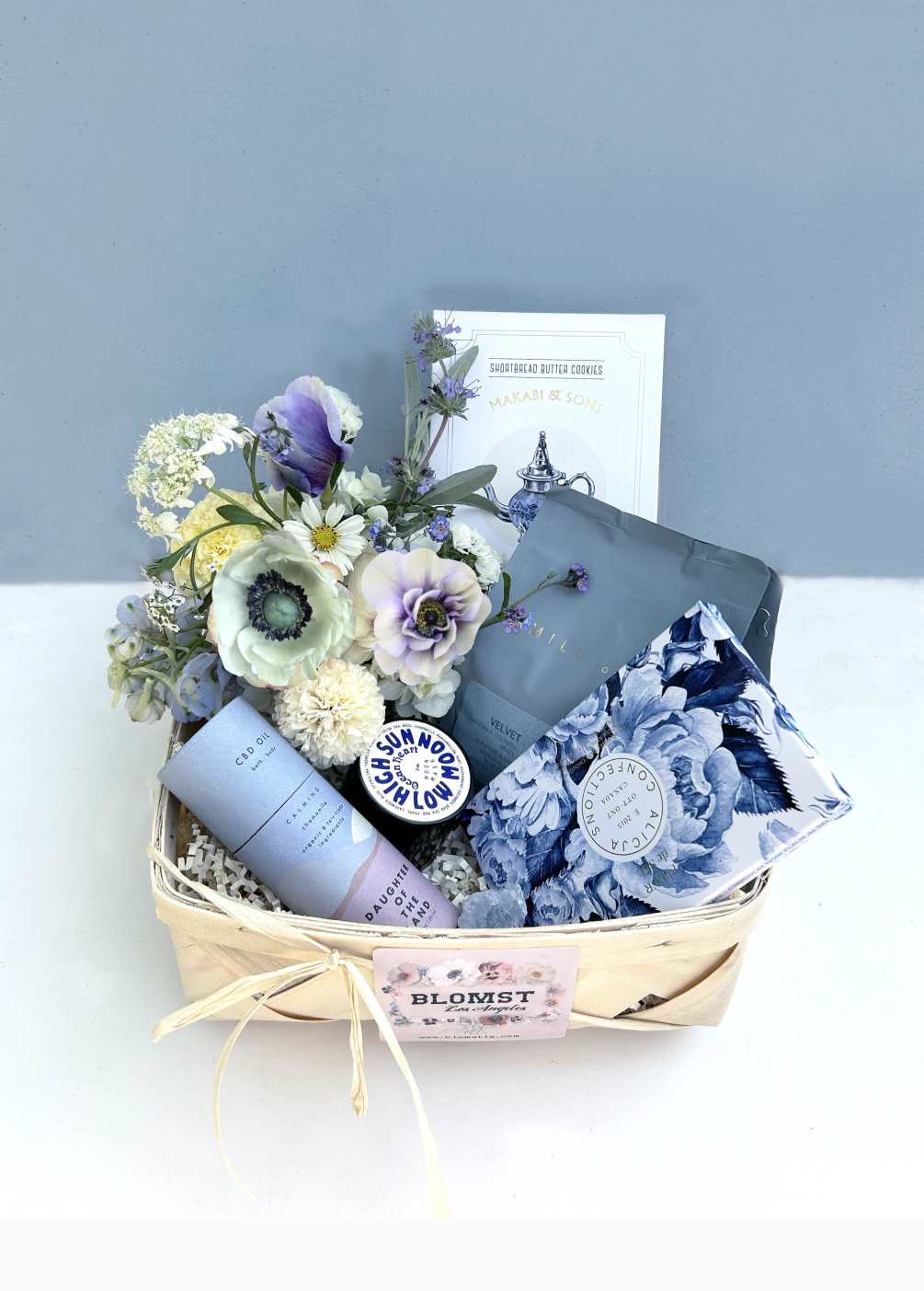 Gorgeous romantic basket full of blue colored, healthy treats, sweets and gifts.