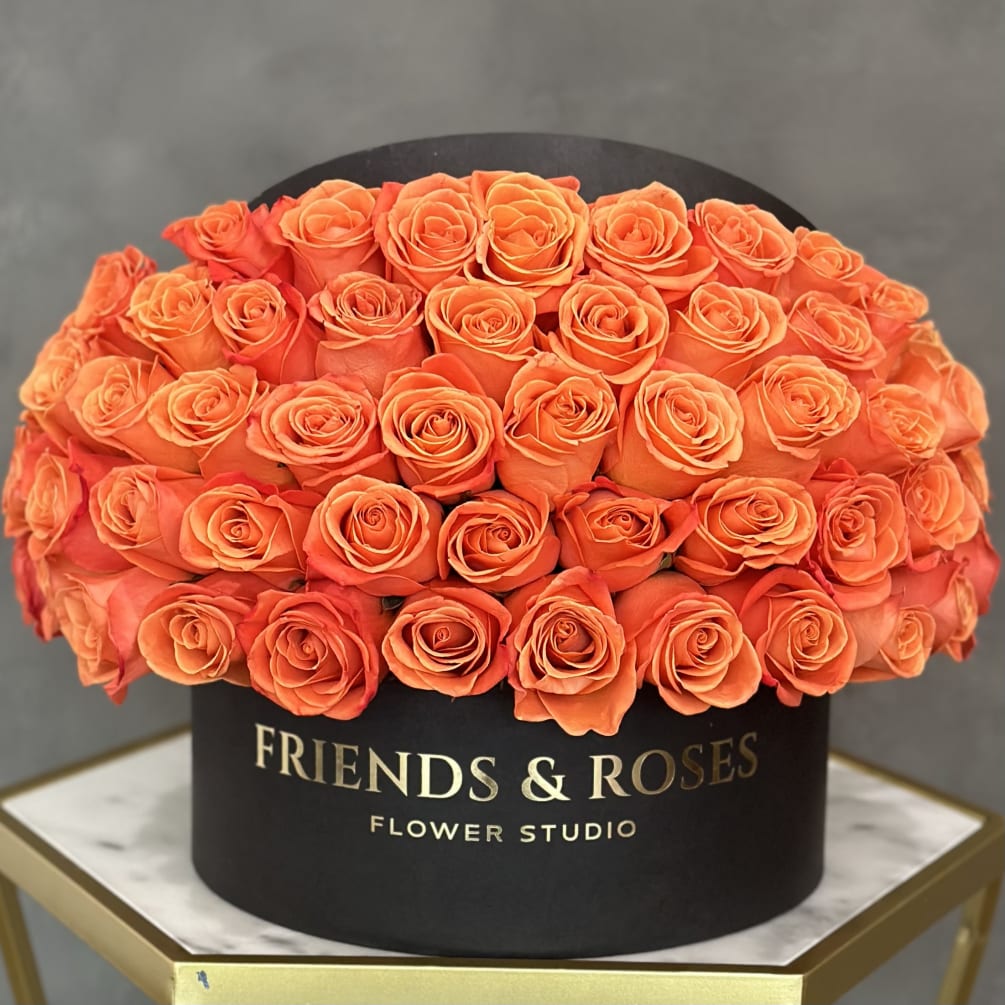 A box filled with flames.
Fresh orange roses in our flat black box