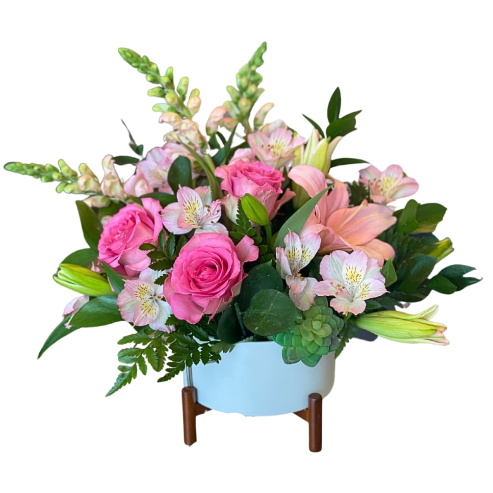 Introducing Enchanted Blossoms - a charming and elegant floral arrangement. Soft pink