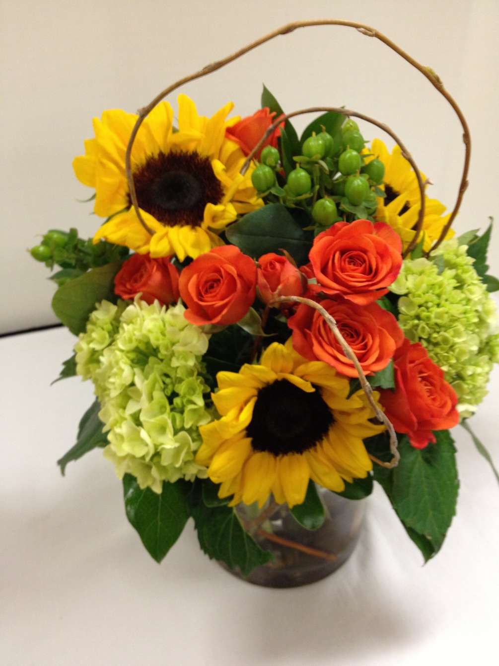 Casual elegance and vivid colors with bright sunflowers, mixed green hydrangeas, and