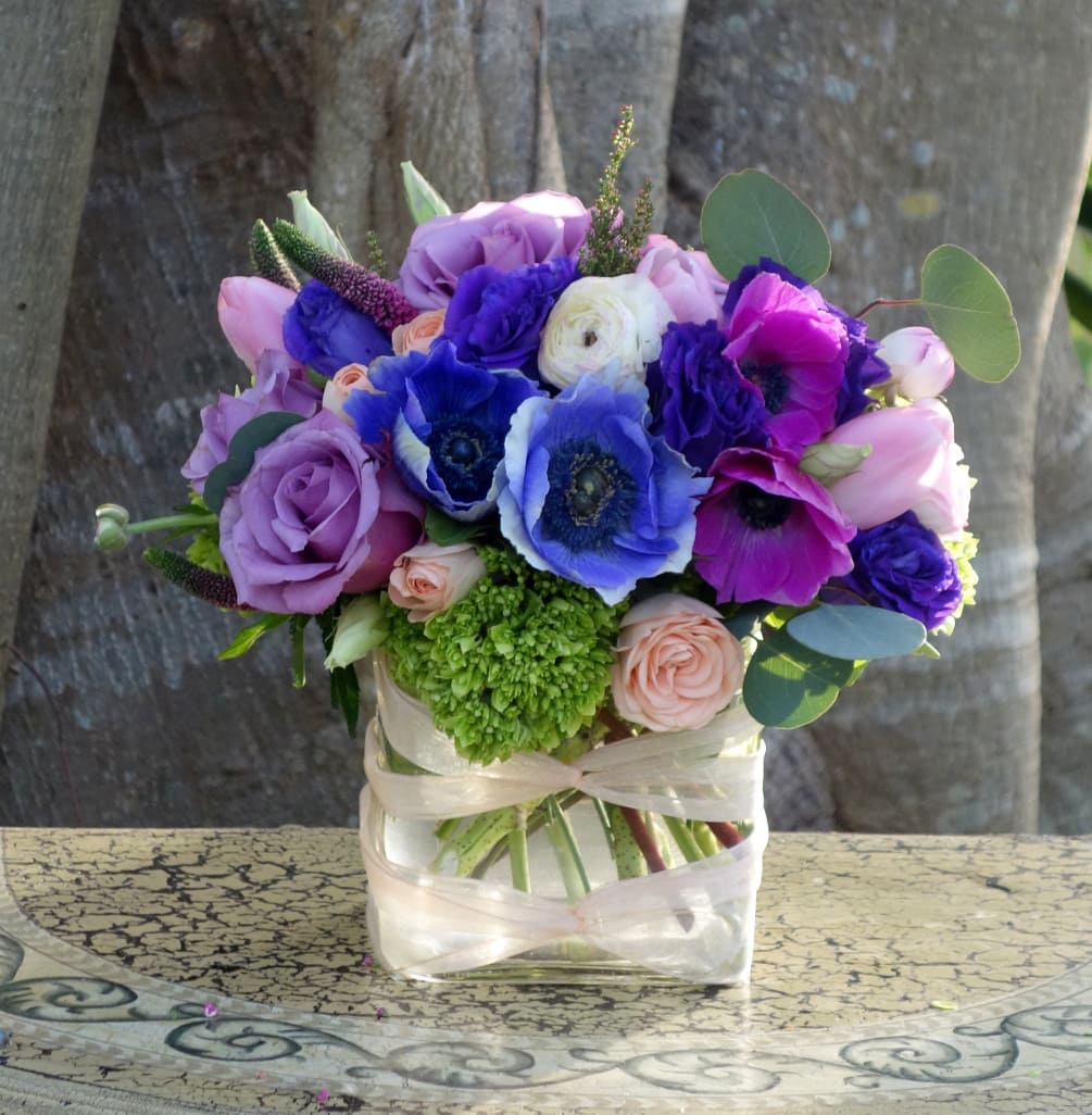 Romantic purple and fuchsia anemones, ranunculus, lavender roses, tulips, dark purple lisianthus