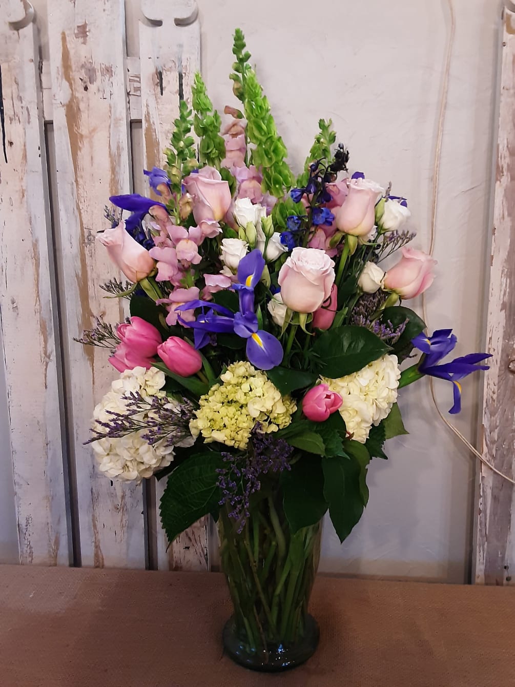 An opulent display of garden flowers in pinks, purples and whites. 