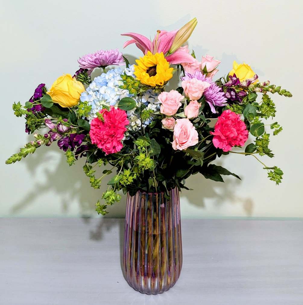 A bright, vibrant colorful medley of the freshest flowers available like blue