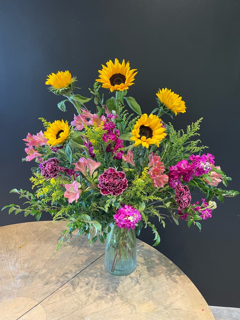 Beautiful sunflowers arranged in a unique vase to give it a wild