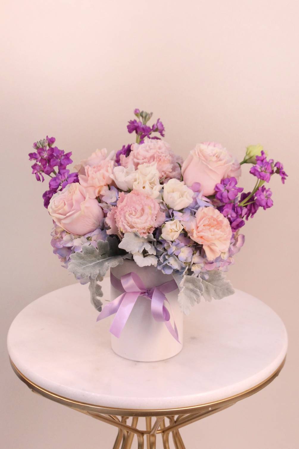 A beautiful shades of pastel flowers in lavender, blush and peach in