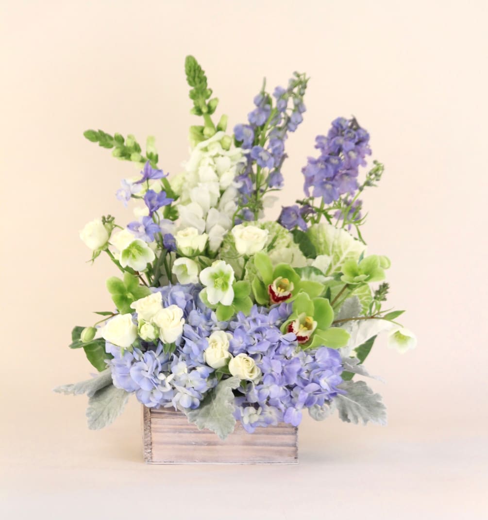 A lush arrangement of blues and whites in a white wash wooden