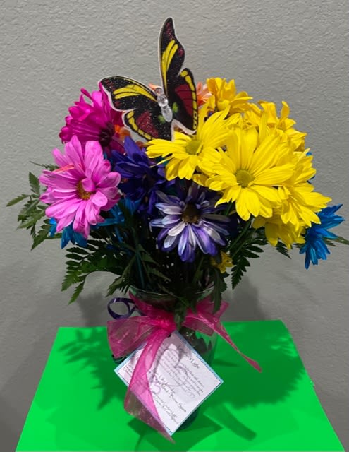 This bouquet is a mix of bright colored flowers in memory of