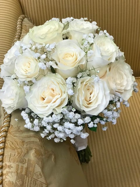 12 creamy roses and baby&#039;s breath. 