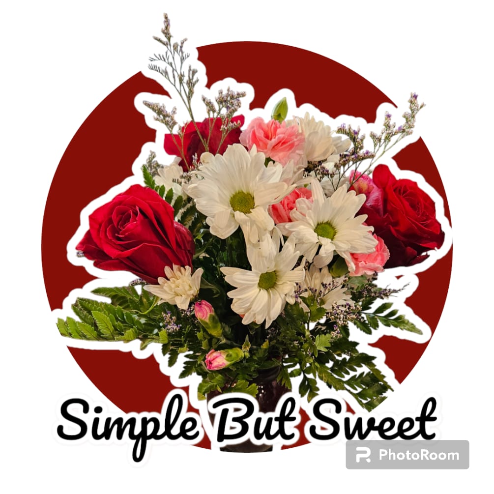 A simple but sweet bouquet of white daisys, red roses and carnations.