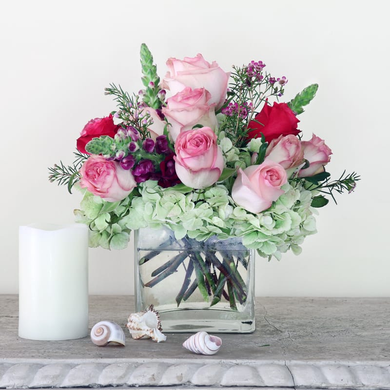 Arranged  with style and sophistication in a clear square vase are