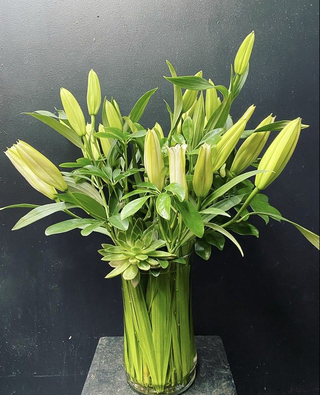 Lilies, succulent, greenery foliage. We use flowers that are available at that